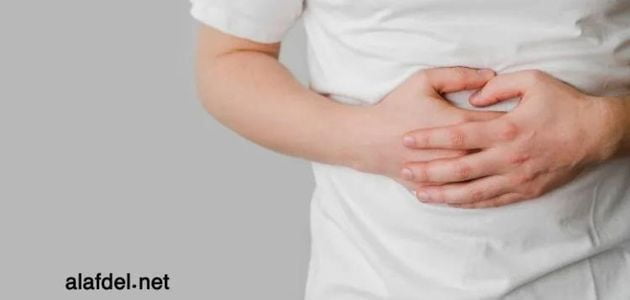 An image of a cancer patient holding his stomach, showing the importance of Forms of nutrition for cancer patients