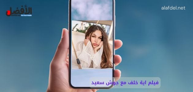 صورة بها يد شخص تمسك هاتف ذكي عليه صورة السورية ايه خلف ضمن الحديث عن فيلم اية خلف مع جوش سعيد